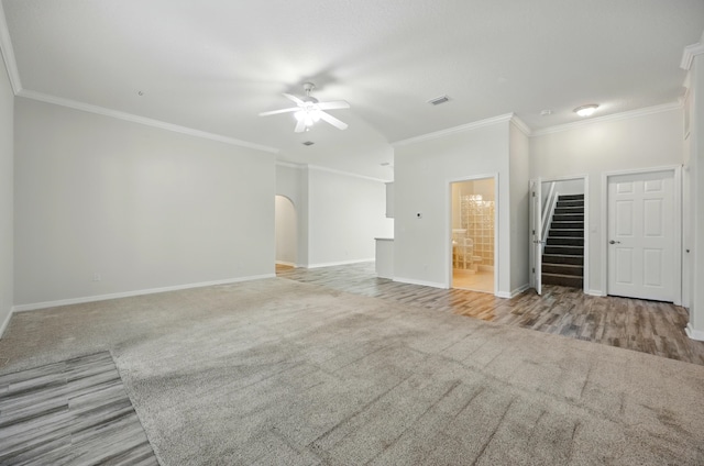 500 Seagate Ln, Saint Augustine, FL 32084 - unfurnished living room featuring a ceiling fan, carpet, ornamental molding, baseboards, and arched walkways