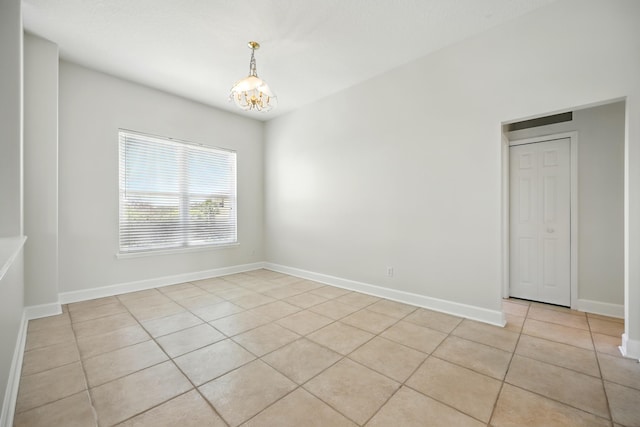 500 Seagate Ln, Saint Augustine, FL 32084 - spare room with light tile patterned flooring, a chandelier, and baseboards
