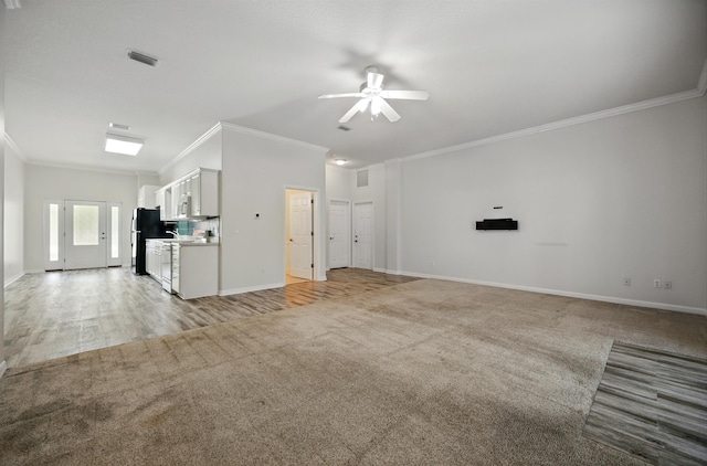 500 Seagate Ln, Saint Augustine, FL 32084 - unfurnished living room featuring ornamental molding, a ceiling fan, light carpet, and baseboards
