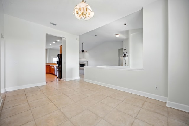 500 Seagate Ln, Saint Augustine, FL 32084 - empty room featuring a chandelier, light tile patterned floors, lofted ceiling, a fireplace, and baseboards