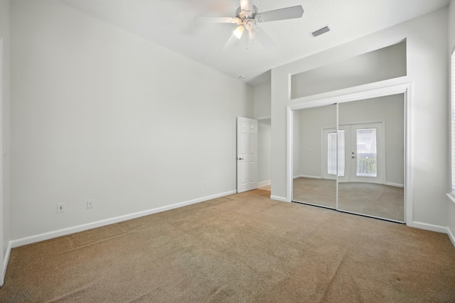 500 Seagate Ln, Saint Augustine, FL 32084 - unfurnished bedroom with carpet floors, french doors, baseboards, a ceiling fan, and a closet