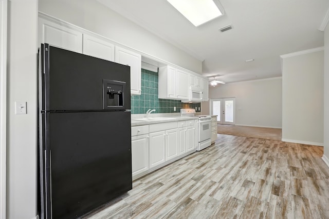 500 Seagate Ln, Saint Augustine, FL 32084 - kitchen with white appliances, crown molding, white cabinets, light countertops, and a sink
