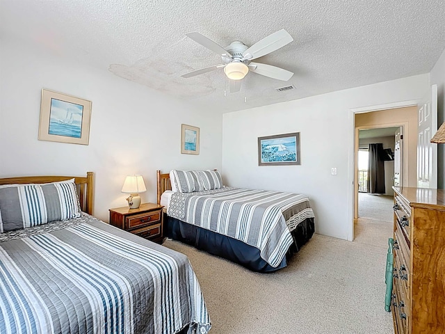 826 A1A Beach Blvd Unit 13, Saint Augustine, FL 32080 - bedroom featuring light colored carpet, a textured ceiling, and ceiling fan