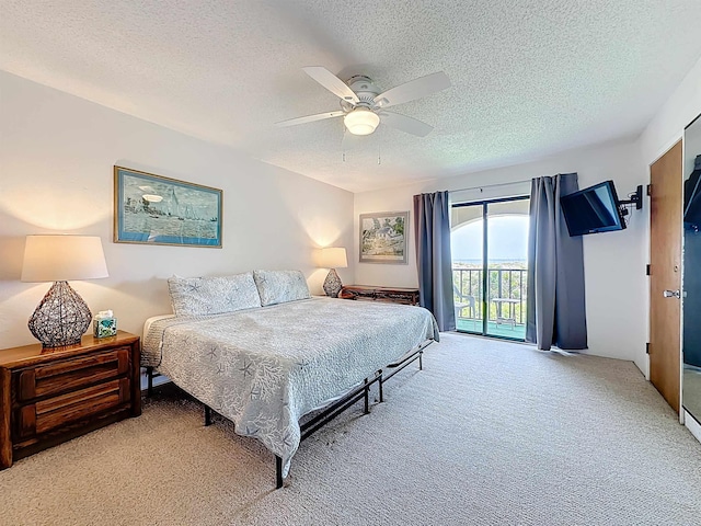 826 A1A Beach Blvd Unit 13, Saint Augustine, FL 32080 - bedroom featuring access to outside, light colored carpet, a textured ceiling, and a ceiling fan