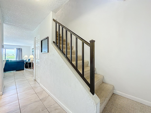 826 A1A Beach Blvd Unit 13, Saint Augustine, FL 32080 - stairway with a textured ceiling and baseboards