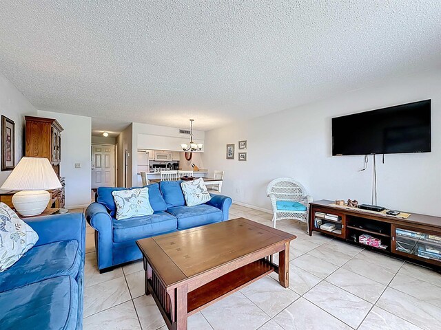 826 A1A Beach Blvd Unit 13, Saint Augustine, FL 32080 - living room featuring a textured ceiling and a chandelier