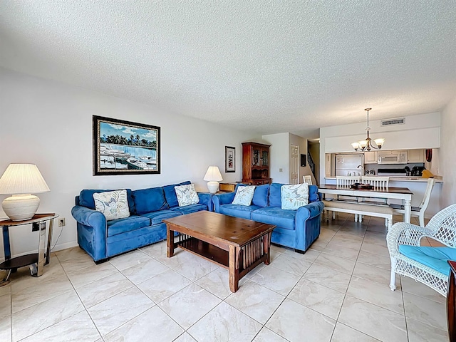 826 A1A Beach Blvd Unit 13, Saint Augustine, FL 32080 - living area featuring a chandelier and a textured ceiling