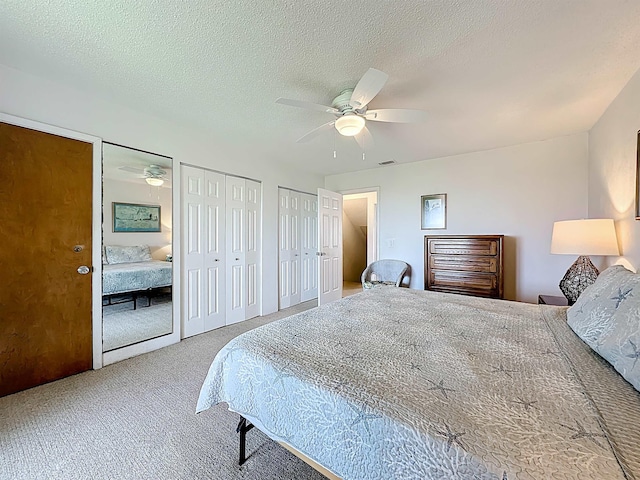 826 A1A Beach Blvd Unit 13, Saint Augustine, FL 32080 - bedroom featuring multiple closets, carpet floors, ceiling fan, and a textured ceiling