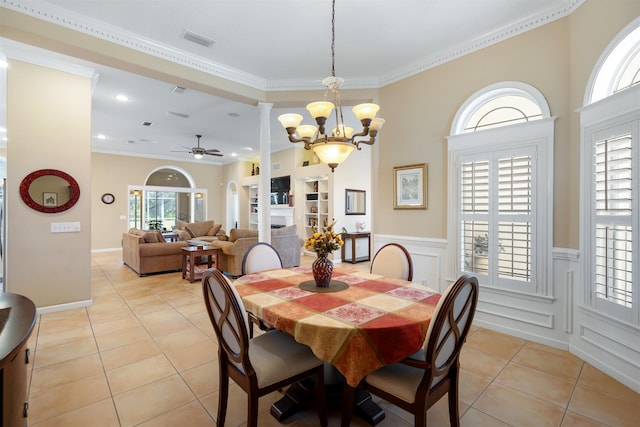 dining space featuring ornamental molding, visible vents, a fireplace, and light tile patterned flooring