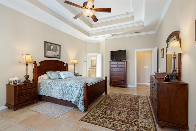 bedroom with light tile patterned flooring, a ceiling fan, baseboards, ornamental molding, and a tray ceiling