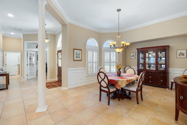 dining space featuring ornate columns, wainscoting, visible vents, and light tile patterned flooring