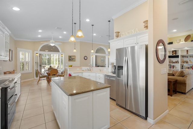 kitchen with white cabinets, a kitchen island, pendant lighting, and stainless steel appliances