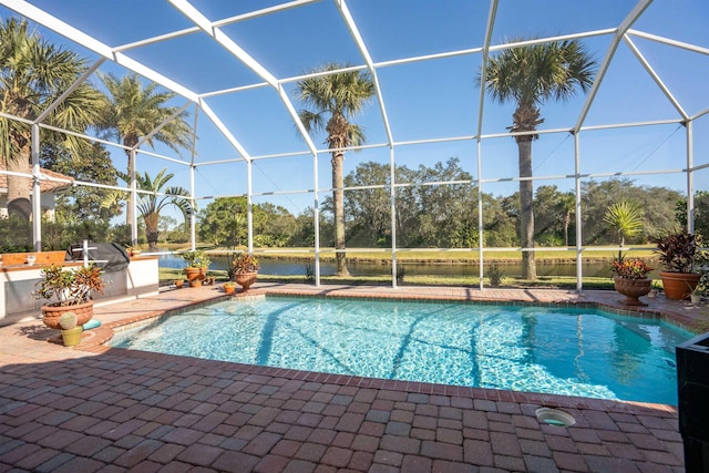 outdoor pool with a patio area and a lanai