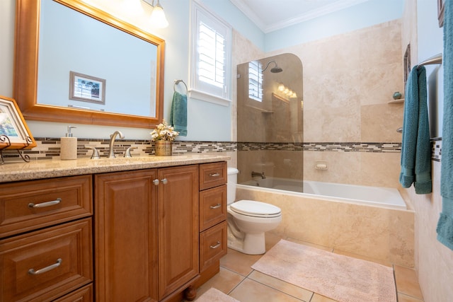 bathroom featuring tile walls, ornamental molding, tiled shower / bath combo, vanity, and tile patterned flooring