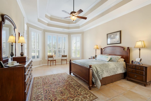 bedroom featuring ornamental molding, a raised ceiling, multiple windows, and light tile patterned floors