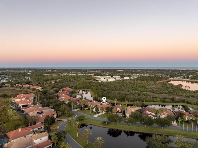 birds eye view of property featuring a water view and a residential view