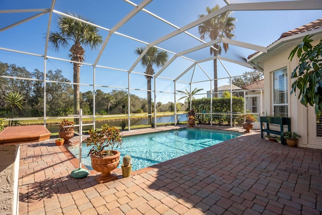 pool with glass enclosure and a patio