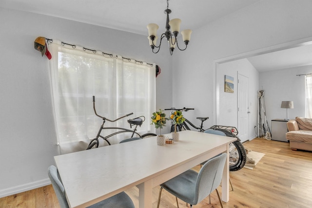 67 Anderson St, Saint Augustine, FL 32084 - dining area featuring light wood-style floors, baseboards, and a chandelier