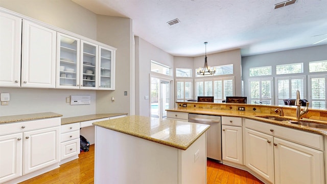 12232 Lashbrook Ct, Jacksonville, FL 32223 - kitchen with dishwasher, a sink, light wood-style floors, and healthy amount of natural light