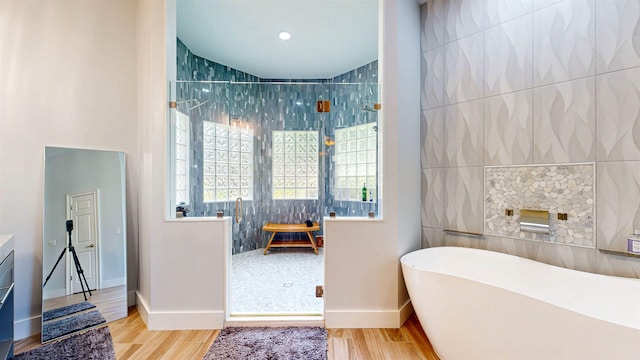 12232 Lashbrook Ct, Jacksonville, FL 32223 - full bath featuring a stall shower, a freestanding tub, wood finished floors, and baseboards