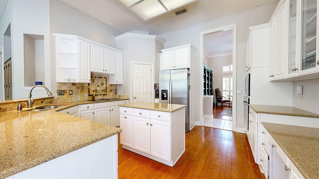 12232 Lashbrook Ct, Jacksonville, FL 32223 - kitchen with a sink, stainless steel appliances, open shelves, light stone countertops, and crown molding