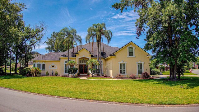 12232 Lashbrook Ct, Jacksonville, FL 32223 - traditional-style house featuring stucco siding, a front lawn, and french doors