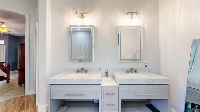 12232 Lashbrook Ct, Jacksonville, FL 32223 - full bathroom featuring double vanity, ceiling fan, wood finished floors, and baseboards