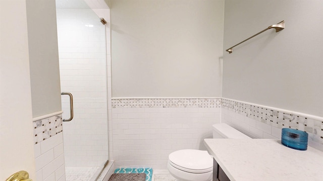 12232 Lashbrook Ct, Jacksonville, FL 32223 - bathroom featuring a stall shower, toilet, a wainscoted wall, tile walls, and vanity