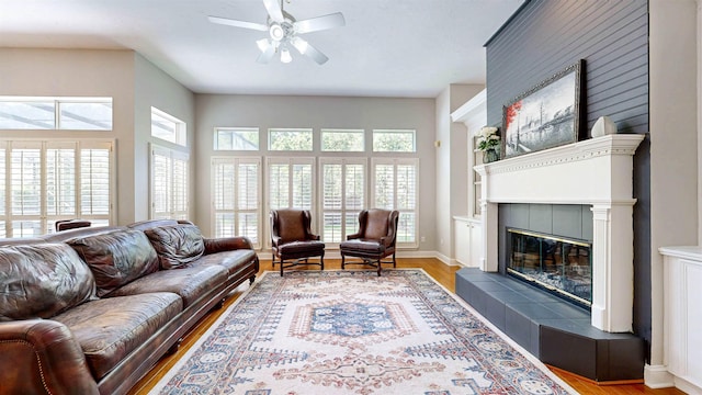 12232 Lashbrook Ct, Jacksonville, FL 32223 - living area with wood finished floors, ceiling fan, plenty of natural light, and a tiled fireplace