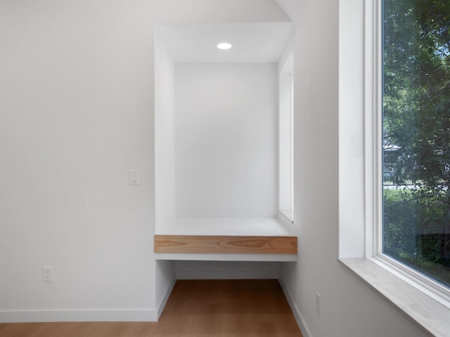mudroom with wood finished floors and baseboards