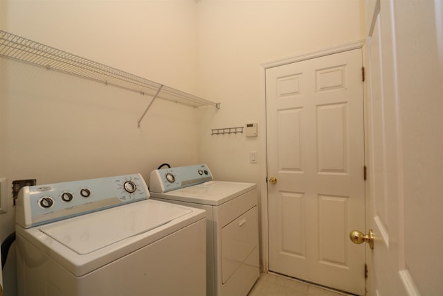 washroom with light tile patterned floors and independent washer and dryer