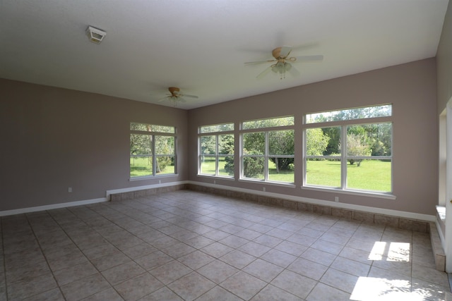 tiled empty room with ceiling fan