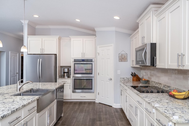 kitchen with white cabinets, decorative light fixtures, and appliances with stainless steel finishes