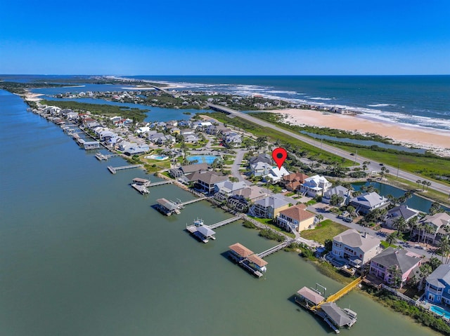 drone / aerial view with a water view and a view of the beach