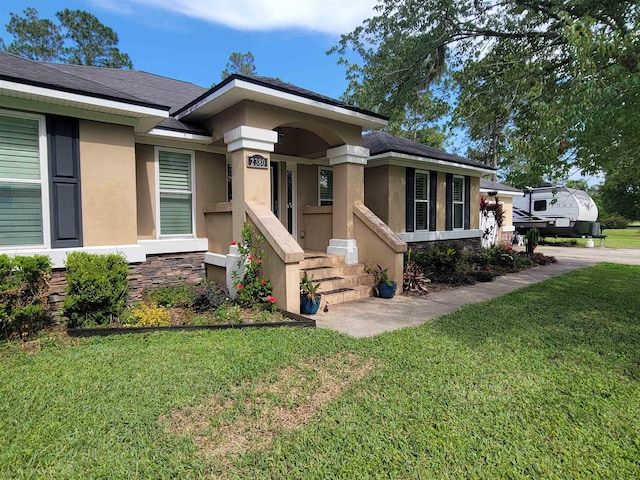 2380 Deerwood Acres Dr, Saint Augustine, FL 32084 - view of front of property featuring stucco siding, a front yard, and stone siding