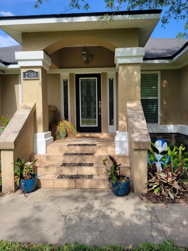 2380 Deerwood Acres Dr, Saint Augustine, FL 32084 - property entrance with a porch and stucco siding