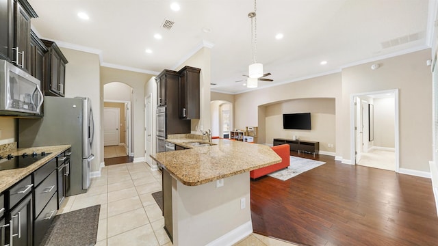 kitchen featuring crown molding, sink, black electric stovetop, and light tile patterned floors