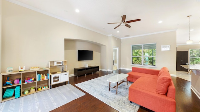 living room featuring crown molding, ceiling fan, and dark hardwood / wood-style flooring