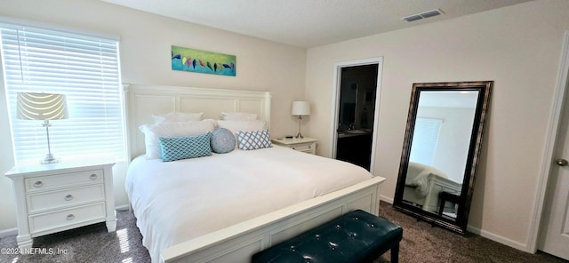 carpeted bedroom with a textured ceiling