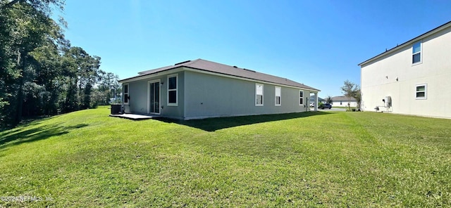 view of home's exterior featuring a lawn and central AC unit