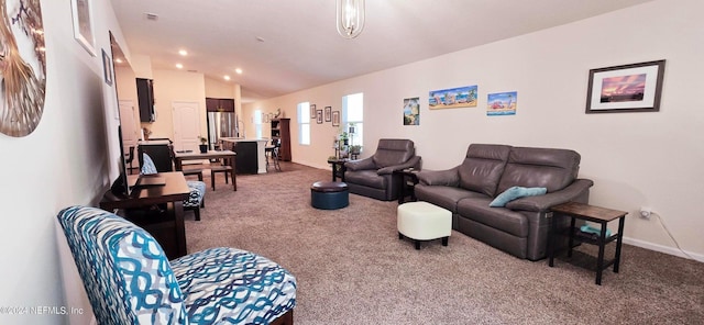 carpeted living room featuring vaulted ceiling