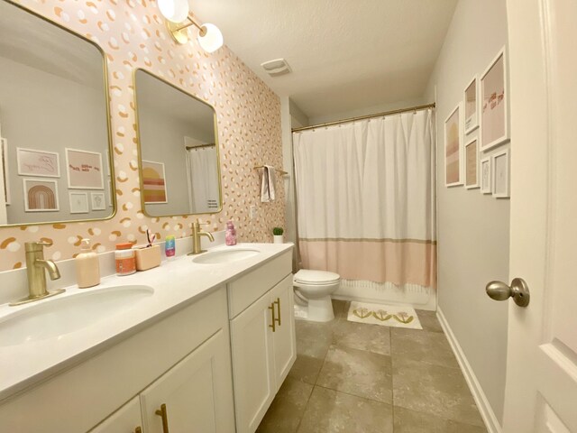 268 Sierras Loop, Saint Augustine, FL 32086 - bathroom featuring toilet, double vanity, tile patterned floors, and baseboards