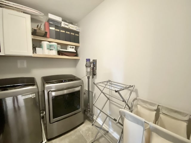 268 Sierras Loop, Saint Augustine, FL 32086 - laundry area with cabinet space, washer and clothes dryer, and light tile patterned floors