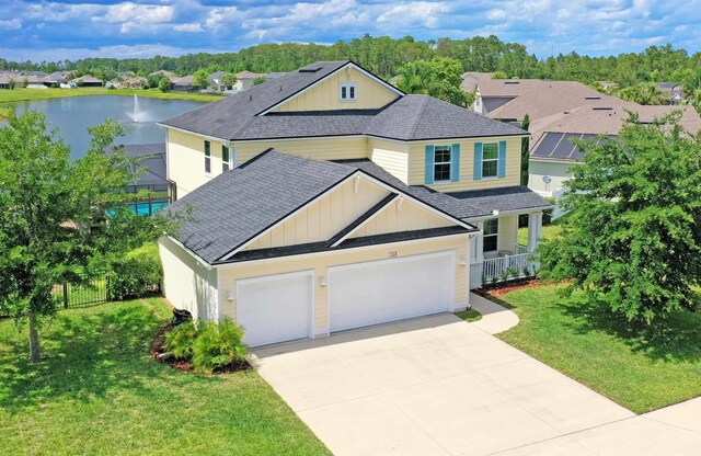 268 Sierras Loop, Saint Augustine, FL 32086 - view of front of property featuring roof with shingles, driveway, a water view, an attached garage, and board and batten siding