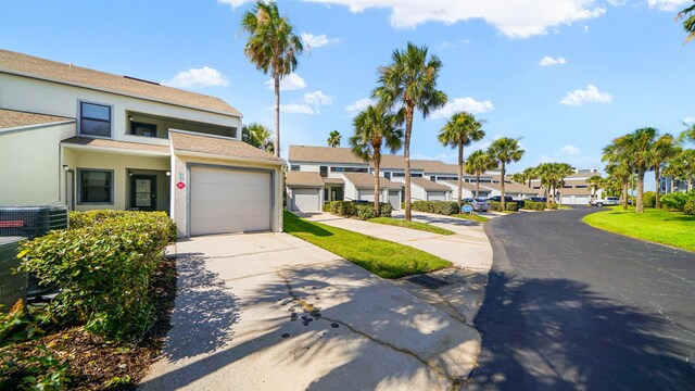 890 A1A Beach Blvd Unit 59, Saint Augustine, FL 32080 - view of front of house with a residential view, driveway, stucco siding, and an attached garage