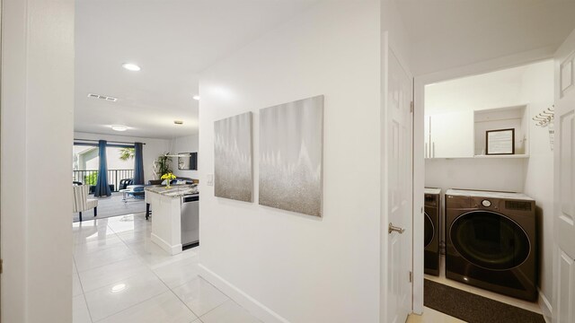 890 A1A Beach Blvd Unit 59, Saint Augustine, FL 32080 - corridor with washer and dryer, light tile patterned floors, and recessed lighting