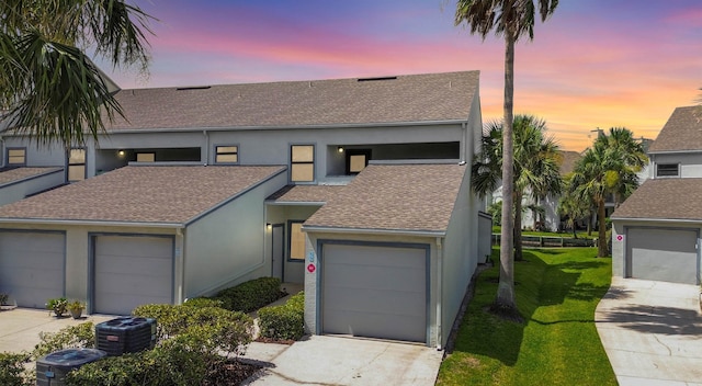 890 A1A Beach Blvd Unit 59, Saint Augustine, FL 32080 - view of front of home with a shingled roof, concrete driveway, stucco siding, and a lawn