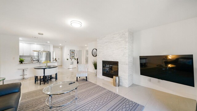 890 A1A Beach Blvd Unit 59, Saint Augustine, FL 32080 - living room with light tile patterned floors, a multi sided fireplace, and recessed lighting