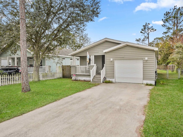 single story home featuring a front lawn, covered porch, and a garage