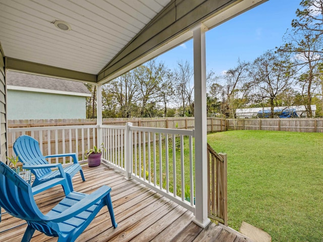 wooden deck featuring a lawn